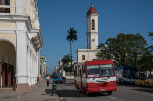 Bus in Cienfuegos with cathedral de Nuestra Señora de la Purísima Concepción in the background, Cuba Bus in Cienfuegos with cathedral de Nuestra Señora de la Purísima Concepción in the background, Cuba